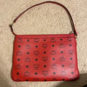 Black on Red MCM bag with gold accents
